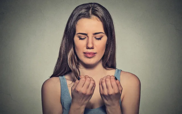 woman looking at her nails